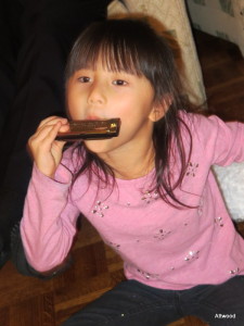 A new harmonica and music stand got Elspeth playing music.